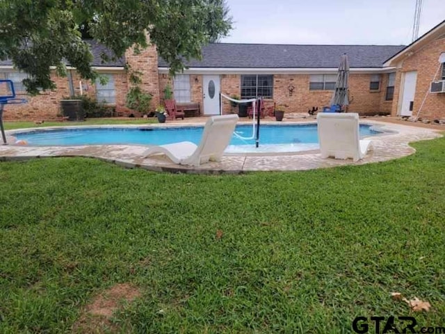 view of pool with a yard