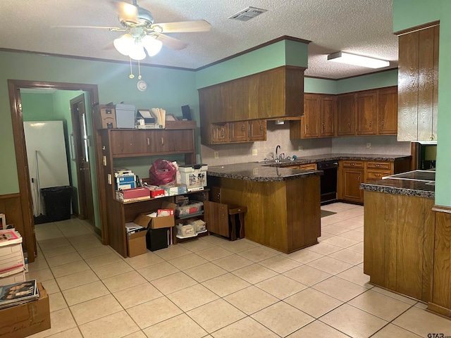 kitchen with black dishwasher, kitchen peninsula, a textured ceiling, sink, and ceiling fan