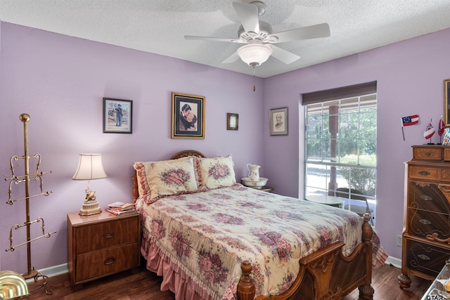 bedroom featuring dark wood-type flooring, ceiling fan, and a textured ceiling