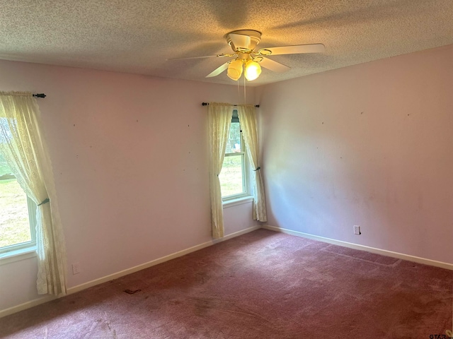 carpeted empty room with a textured ceiling and ceiling fan