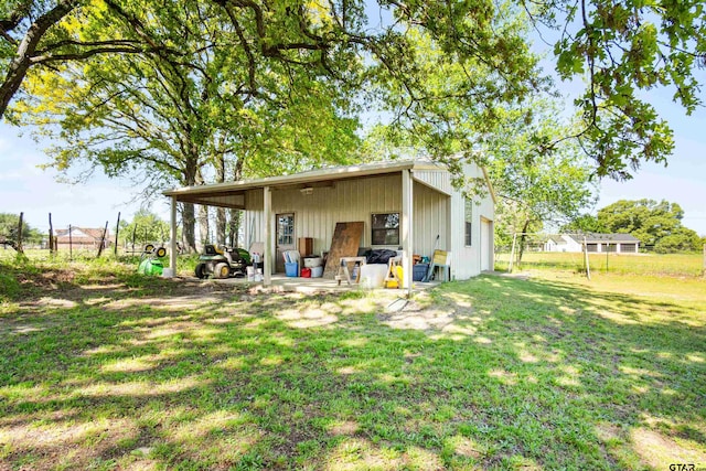 back of property featuring a lawn