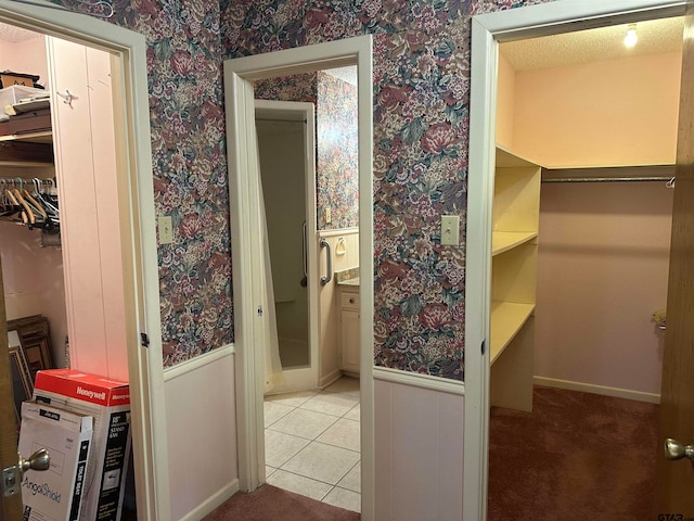 bathroom featuring a textured ceiling and tile patterned floors