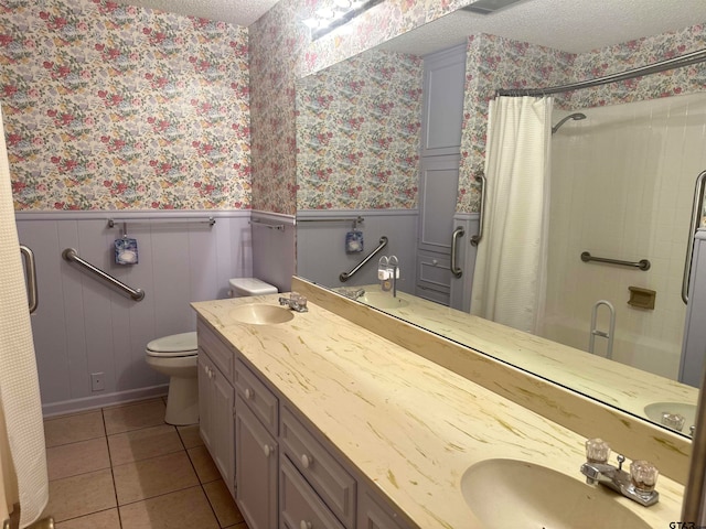 bathroom with tile patterned floors, a shower with curtain, vanity, a textured ceiling, and toilet