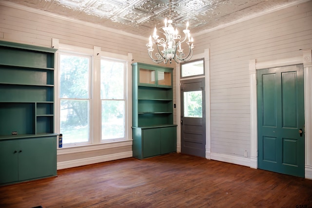 unfurnished dining area featuring a wealth of natural light and dark wood-type flooring