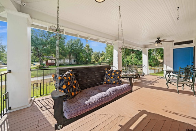 wooden deck featuring ceiling fan