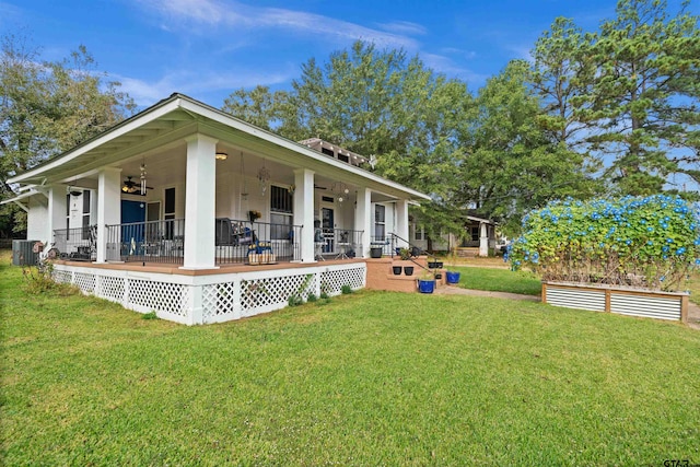 back of property featuring ceiling fan, a lawn, and a porch