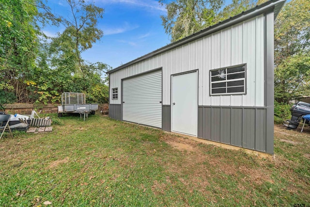 view of outbuilding featuring a lawn