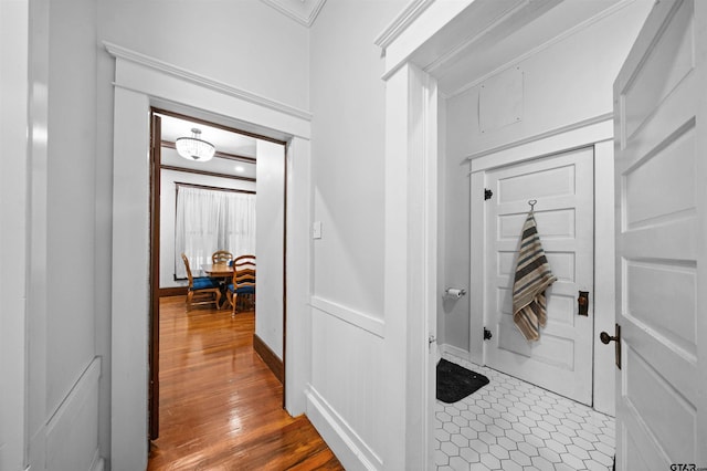 mudroom with wood-type flooring and ornamental molding