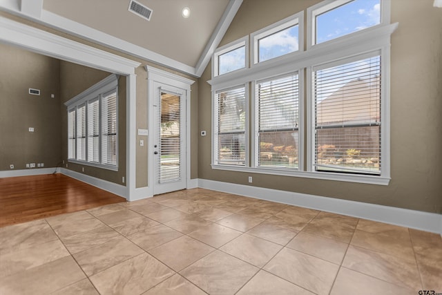 2312 Pinehurst Dr, Tyler, TX 75703 - empty room with baseboards, light tile patterned floors, and high vaulted ceiling