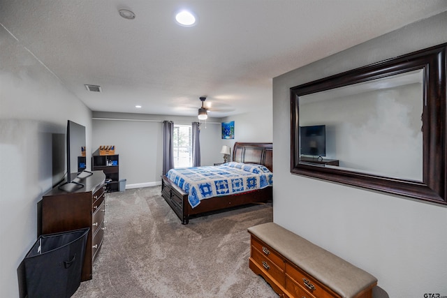 bedroom featuring a textured ceiling, carpet flooring, and ceiling fan