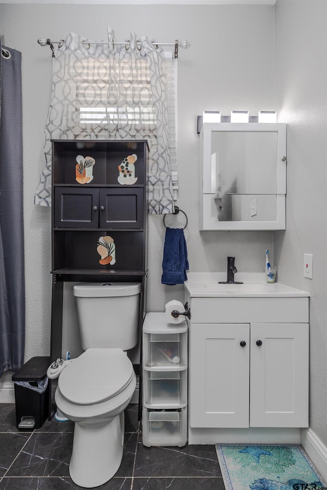 bathroom featuring vanity and toilet