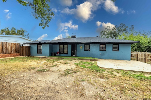 back of house with central AC, a patio area, and a yard