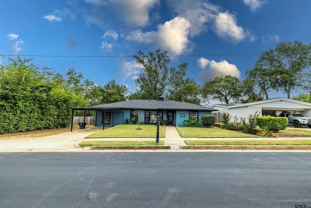 ranch-style house with a front yard and a carport