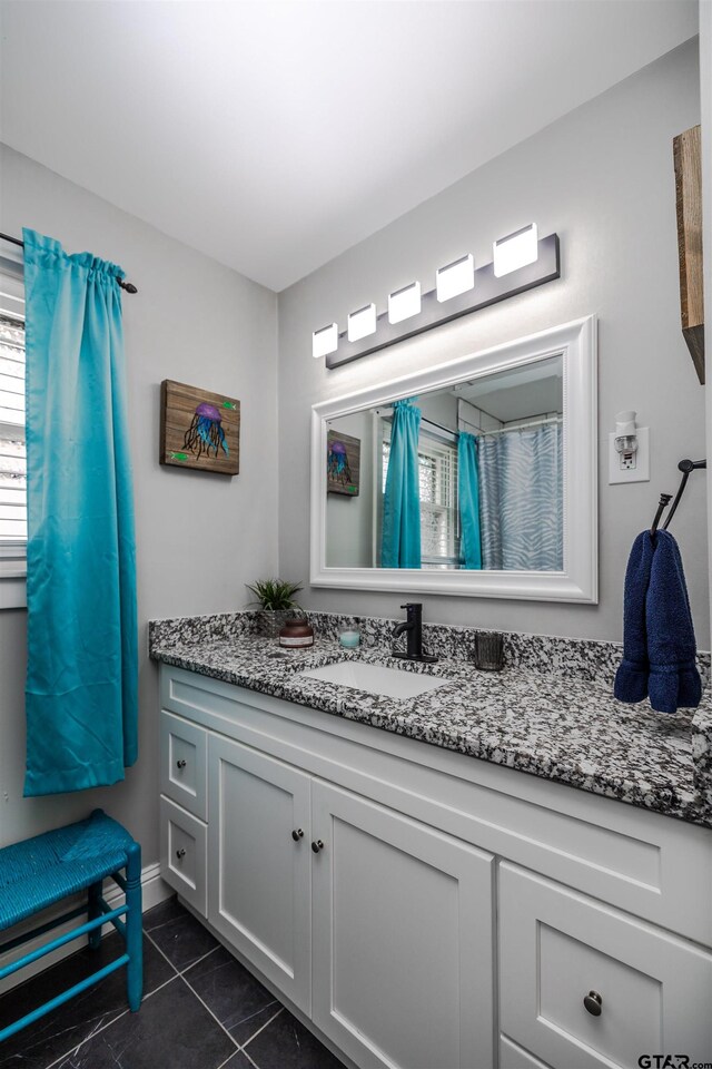 bathroom with tile patterned flooring and vanity