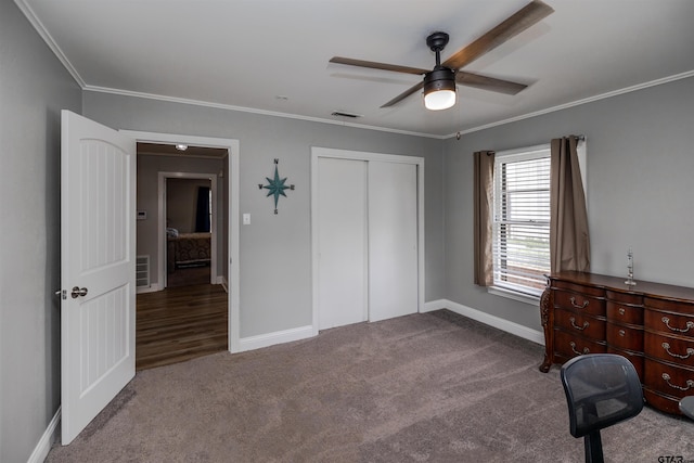 unfurnished bedroom featuring ceiling fan, ornamental molding, a closet, and carpet