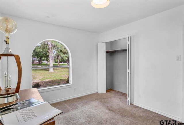 415 Lonestar Ln, Hideaway, TX 75771 - unfurnished bedroom with carpet floors, baseboards, and a closet