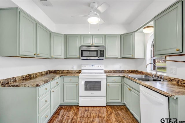 415 Lonestar Ln, Hideaway, TX 75771 - kitchen featuring white appliances, green cabinetry, a sink, a ceiling fan, and wood finished floors