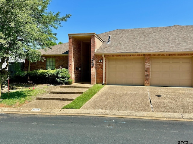 415 Amberwood Cir, Tyler, TX 75701 - view of front of home featuring an attached garage, brick siding, concrete driveway, and a shingled roof