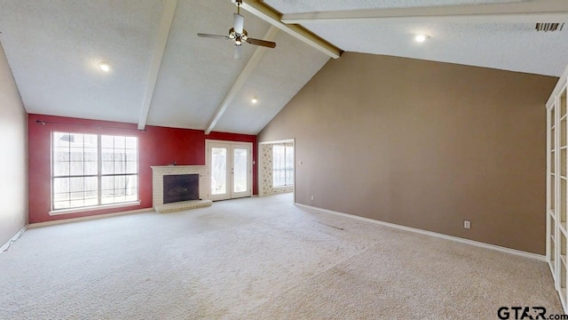 415 Amberwood Cir, Tyler, TX 75701 - unfurnished living room featuring beam ceiling, carpet flooring, a brick fireplace, plenty of natural light, and baseboards
