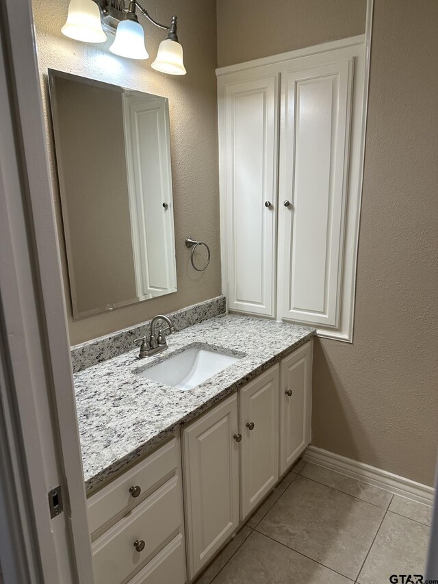 bathroom with tile patterned floors and vanity