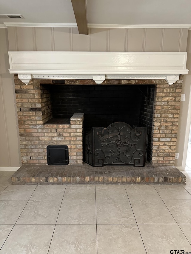 room details featuring beam ceiling and a brick fireplace