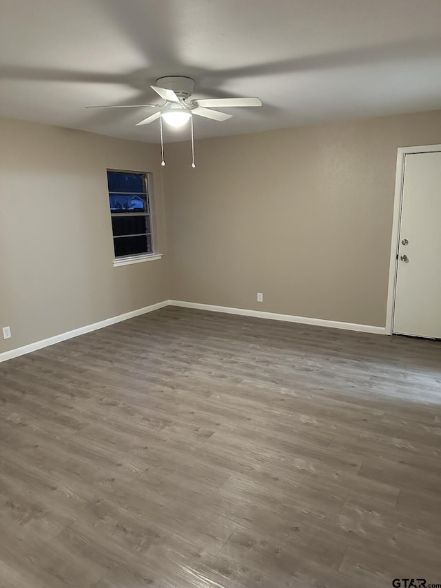 unfurnished room with ceiling fan and hardwood / wood-style flooring