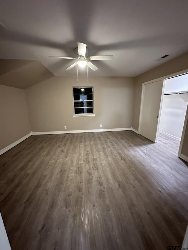 interior space with ceiling fan, wood-type flooring, and vaulted ceiling