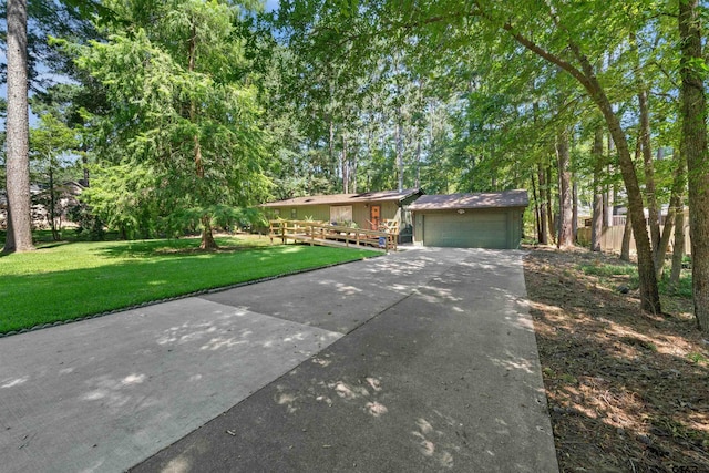 ranch-style house featuring a garage, a front lawn, and a wooden deck