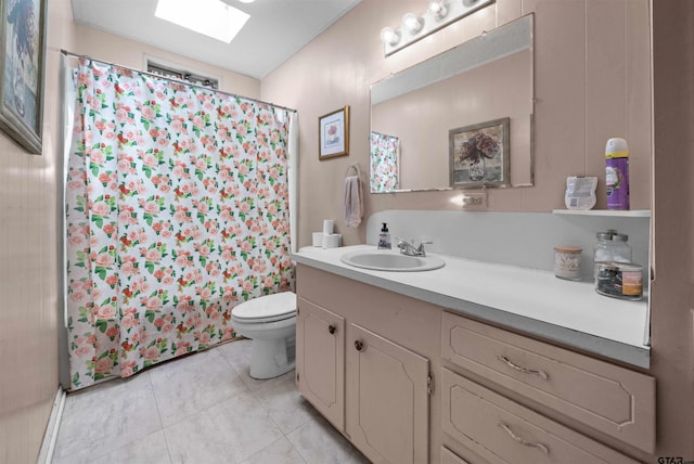 bathroom with a skylight, walk in shower, vanity, tile patterned flooring, and toilet