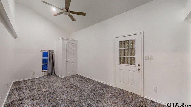 unfurnished room featuring ceiling fan, dark carpet, and high vaulted ceiling