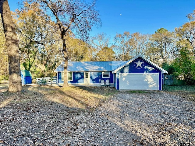 ranch-style house with covered porch and a garage