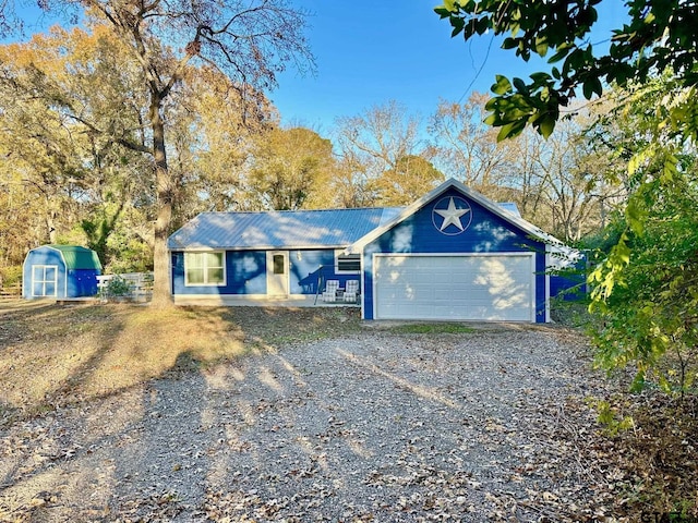 single story home with a garage and a storage shed