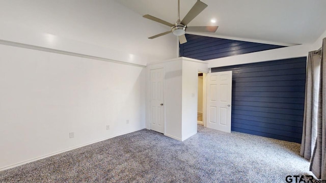 unfurnished bedroom with ceiling fan, carpet, and vaulted ceiling