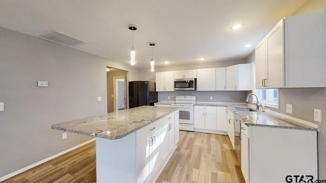 kitchen with white cabinetry, sink, white electric range oven, black fridge with ice dispenser, and a kitchen island