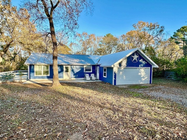 single story home featuring a patio area, a front yard, and a garage