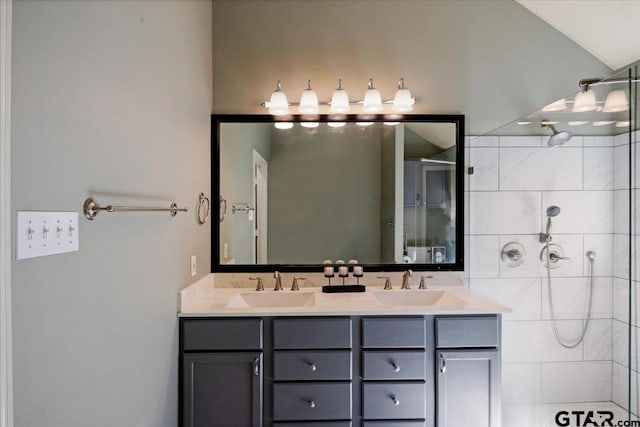 5609 Andover Dr, Tyler, TX 75707 - bathroom featuring double vanity, a tile shower, and a sink