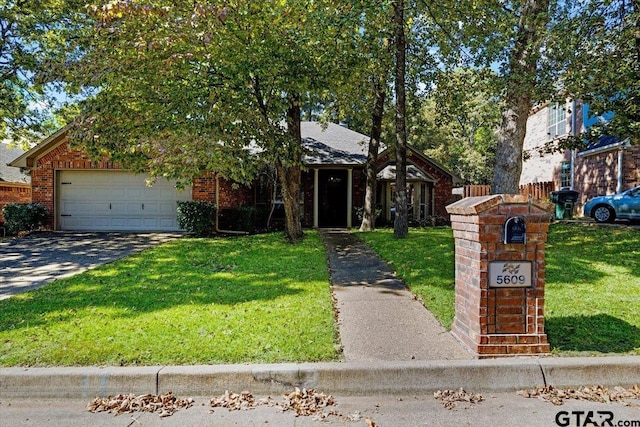 5609 Andover Dr, Tyler, TX 75707 - view of property hidden behind natural elements featuring driveway, a front yard, brick siding, fence, and an attached garage