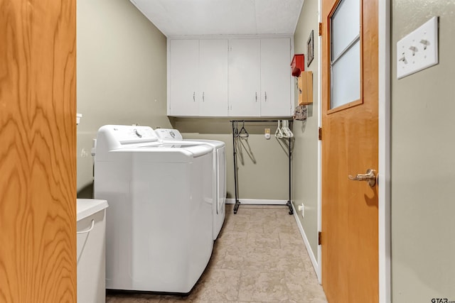 laundry area with cabinets and washer and dryer