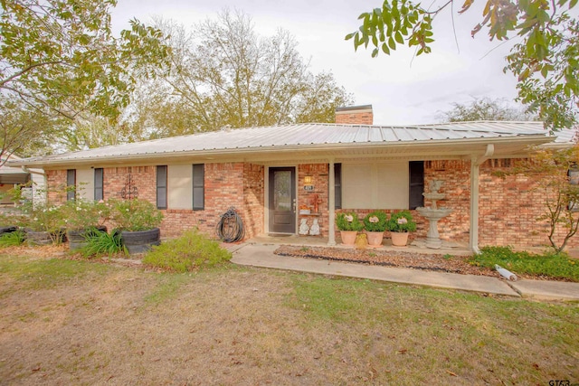 single story home with covered porch and a front lawn