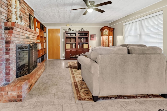 living room featuring ceiling fan and a brick fireplace