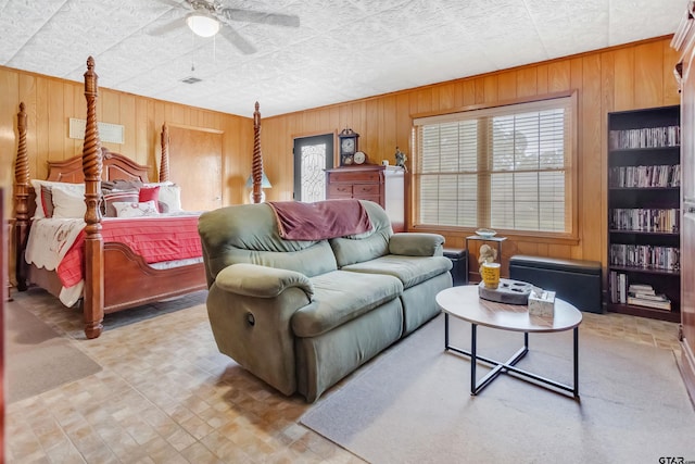 living room with wooden walls and ceiling fan