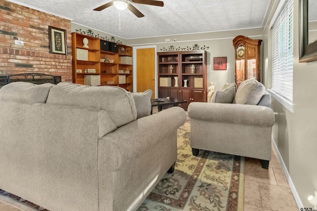 tiled living room featuring a brick fireplace and ceiling fan