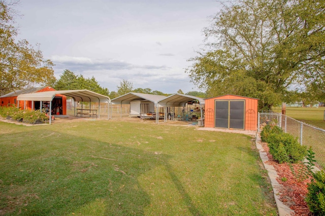 view of yard featuring a storage unit and a carport