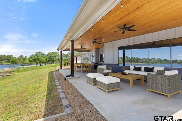 view of patio with an outdoor living space, ceiling fan, outdoor dining area, and a water view