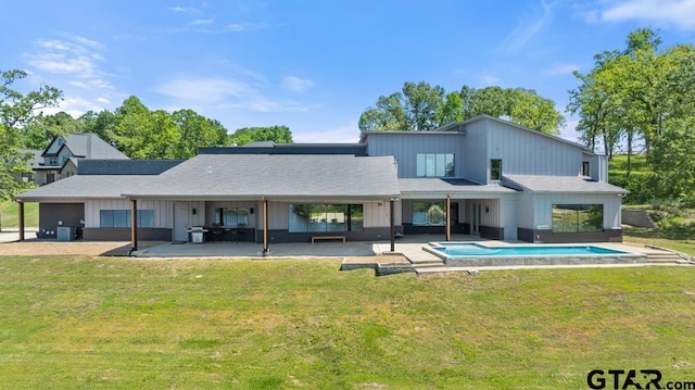 back of house with a lawn, an outdoor pool, and a patio