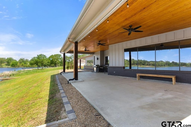 view of patio featuring a ceiling fan and a water view