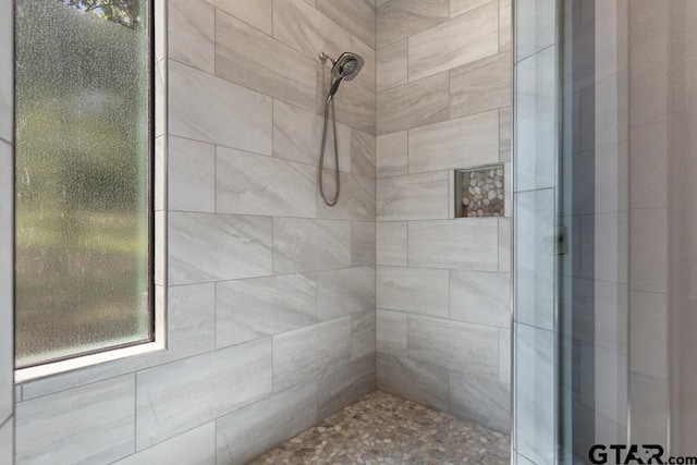 full bath with tiled shower