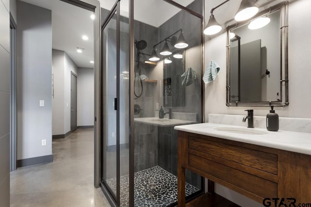 full bath featuring recessed lighting, vanity, baseboards, finished concrete flooring, and a stall shower