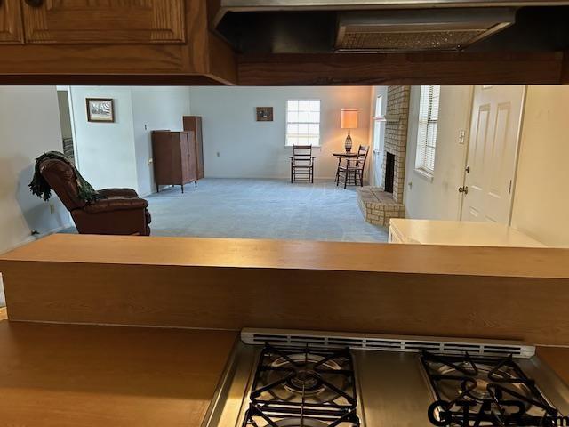 interior space with light colored carpet and a fireplace