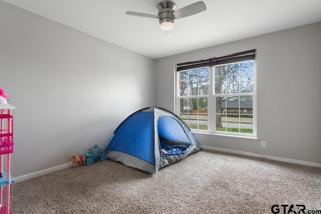 unfurnished bedroom with carpet flooring, a ceiling fan, and baseboards